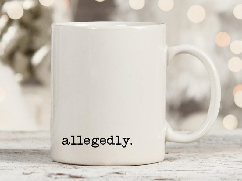 May include: White ceramic coffee mug with the text "allegedly." printed in black on the front.