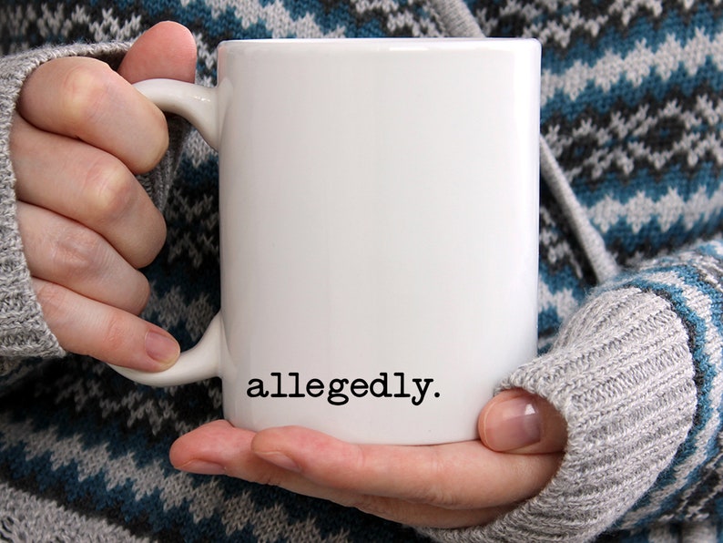 May include: White ceramic coffee mug with the word "allegedly." printed in black on the front.