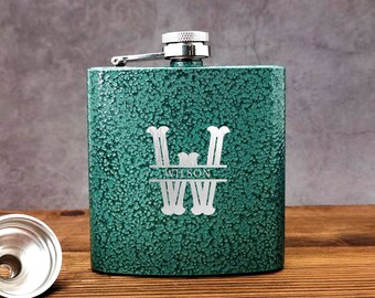 May include: A green metal flask with a silver lid and a monogrammed design. The monogram is a large "W" with the name "Wilson" underneath.