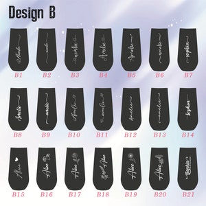 May include: Twenty-one black tumbler cups with various designs. The designs include names like "Amelie" and "Sophia", as well as floral patterns and a heart. The cups are labeled with letters B1 through B21.