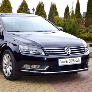 May include: A black Volkswagen Passat saloon with a chrome grille and the text "Power Design" on the front bumper.