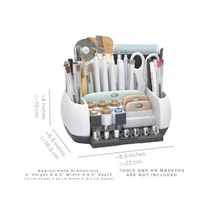 May include: White and gray craft organizer with multiple compartments for tools. It measures approximately 4 inches (10 cm) high, 8.5 inches (22 cm) wide, and 6.5 inches (16.5 cm) deep. Tools and markers are not included.