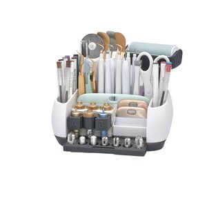 May include: A white and gray craft organizer filled with various tools, including pens, scissors, spatulas, and cutting blades. The organizer has multiple compartments and a dark gray base, ideal for crafting and DIY projects.
