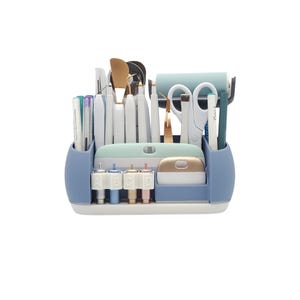 May include: A blue and white craft organizer filled with various tools. The organizer has multiple compartments holding pens, scissors, tweezers, and other crafting essentials. The tools are in shades of white, gold, and teal.