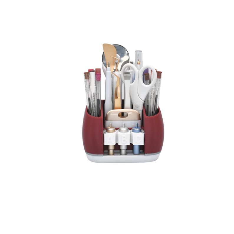 May include: A red and white craft organizer filled with various tools. The organizer holds pens, scissors, tweezers, and other crafting implements. The organizer has a white base and a red upper section. The tools are arranged for easy access.