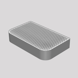 Puede incluir: Un altavoz rectangular gris con una rejilla hexagonal de malla en la parte superior.
