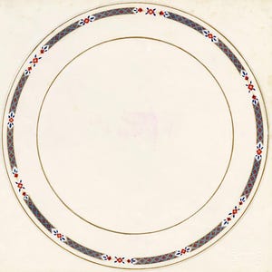 May include: A cream-colored plate with a gold rim and a decorative border. The border features a repeating pattern of red, blue, and gray geometric shapes and floral accents. The plate has a simple, elegant design.