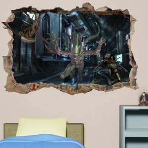 May include: A 3D wall decal depicting a scene from the Alien film franchise. The decal shows a green and black alien creature emerging from a cracked wall, with another alien creature in the background.