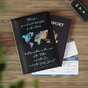 May include: Black passport holder with a world map design in multiple colors and the text "Therefore go and make disciples of all nations". A U.S. passport, plane tickets, and car keys are also visible.