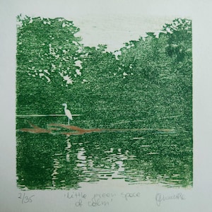 May include: A square print featuring a white heron standing on a brown log in a dark green body of water, surrounded by dense green trees. The text 2/35, 'little green space of calm', and a signature are written in pencil below the image.