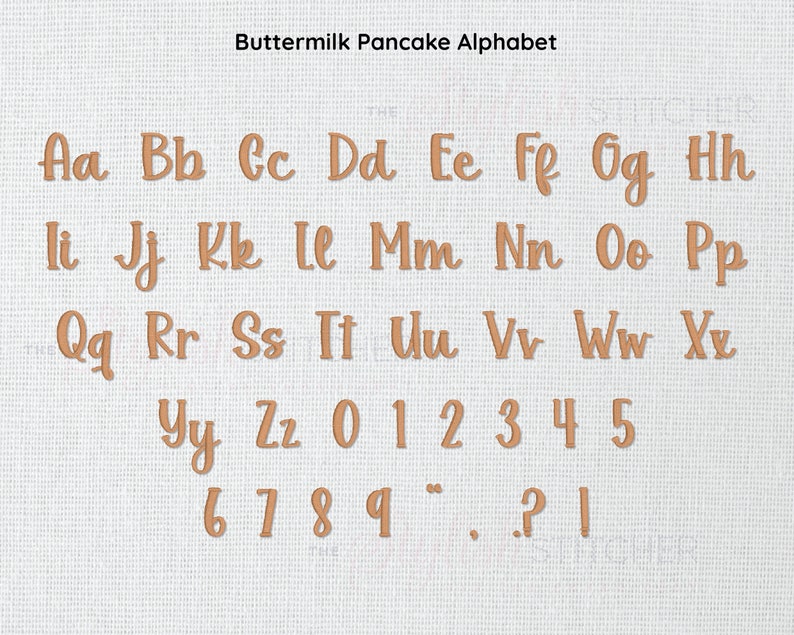 May include: Buttermilk Pancake Alphabet. A set of brown, felt-like letters and numbers, including punctuation marks, arranged in rows on a white, textured background.