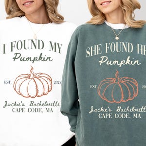 May include: Two long-sleeved sweatshirts, one white and one teal, with pumpkin graphics. The white sweatshirt reads "I FOUND MY Pumpkin" and the teal one says "SHE FOUND HER Pumpkin". Both include "Jackie's Bachelorette, Cape Code, MA".