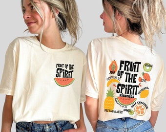 May include: A white t-shirt with a graphic of a watermelon and the text "Fruit of the Spirit" on the front. The back of the shirt has a graphic of various fruits with the text "Fruit of the Spirit" and a list of the fruits of the spirit: "Love, Joy, Peace, Patience, Kindness, Goodness, Faithfulness, Gentleness, Self-Control".
