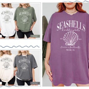 May include: Four oversized t-shirts with a seashell graphic and the text "Seashells & Wedding Bells" in white. The shirts are in white, green, purple, and gray.