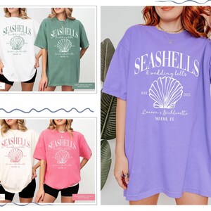 May include: Four different colored oversized t-shirts with a seashell graphic and the text "Seashells & wedding bells est. 2025 Lauren's Bachelorette Miami, FL"