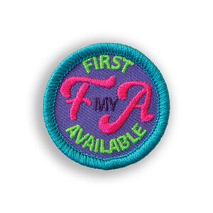 May include: A purple fabric patch with a green border and the text "FIRST MY AVAILABLE" in a pink and green font.