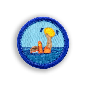 May include: Blue and orange embroidered patch with a person wearing a life jacket and holding a yellow ball in the water.