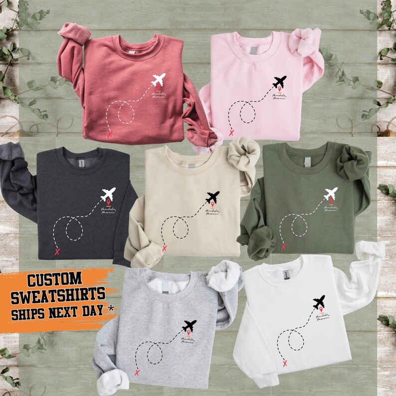 a group of children's sweaters on a wooden background