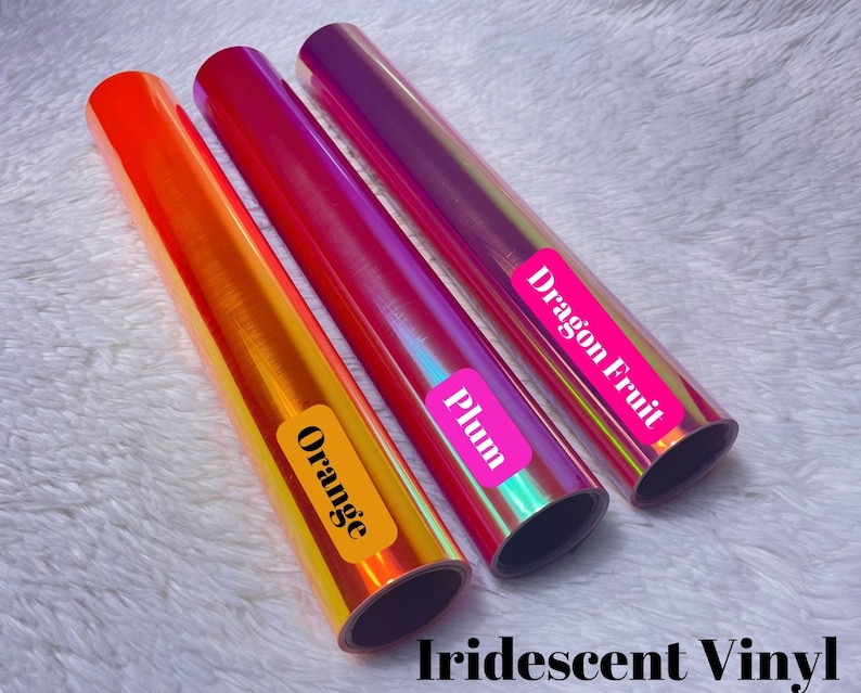 May include: Three rolls of iridescent vinyl in orange, plum, and dragon fruit colors. The vinyl is rolled up and labeled with the color name.