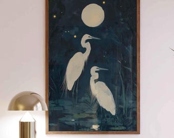 May include: A framed print of two white egrets standing in a dark blue pond under a full moon. The moon is surrounded by a ring of small yellow stars.