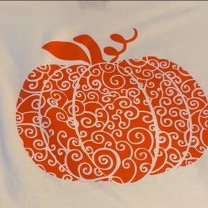May include: Orange pumpkin with a white swirl design. The pumpkin is on a white background.