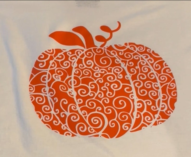 May include: Orange pumpkin with a white swirl design. The pumpkin is on a white background.