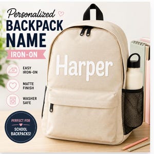 May include: A beige backpack featuring the white iron-on name Harper in a sans-serif font. The bag has a main zippered compartment, a front pocket, and a black mesh side pocket holding a white water bottle. Text on the image includes Personalized Backpack Name, Iron-on, Easy Iron-on, Matte Finish, Washer Safe, and Perfect for School Backpacks.