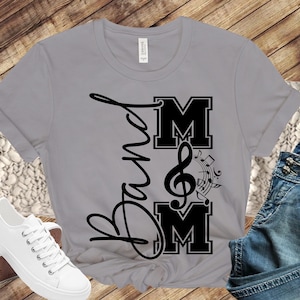 May include: Gray t-shirt with black text that says "Band Mom" and a treble clef with music notes.