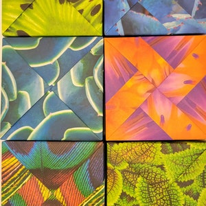 May include: Six square tiles with different patterns. Each tile has a different plant pattern, including a green and black pattern, a blue and white pattern, an orange and purple pattern, a blue and green pattern, a green and brown pattern, and a green and yellow pattern.