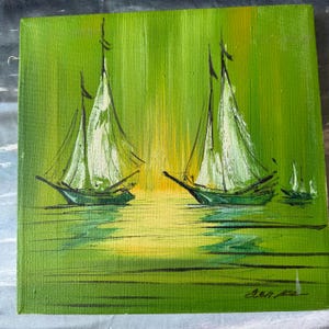May include: A square painting of sailboats on water. The artwork features a green and yellow background with three sailboats. The sails are white, and the boats are dark green. The painting has a textured appearance.