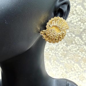 May include: A set of three ceramic mugs with a speckled, matte finish. The mugs are in shades of cream, light gray, and dark gray. Each mug has a simple, minimalist design and a rounded handle. The mugs are stacked on top of each other.