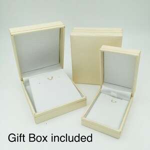 May include: Three cream-colored gift boxes, two open and one closed, with white interiors. The open boxes have a small hook for jewelry. The text "Gift Box included" is at the bottom of the image.