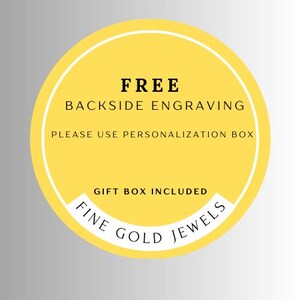 May include: A yellow circular sticker with white and black text. The text reads "FREE BACKSIDE ENGRAVING, PLEASE USE PERSONALIZATION BOX, GIFT BOX INCLUDED, FINE GOLD JEWELS."