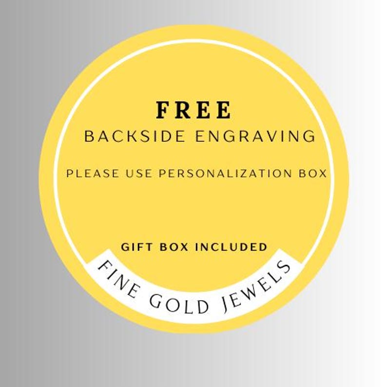 May include: A yellow circular sticker with white and black text. The text reads "FREE BACKSIDE ENGRAVING, PLEASE USE PERSONALIZATION BOX, GIFT BOX INCLUDED, FINE GOLD JEWELS."