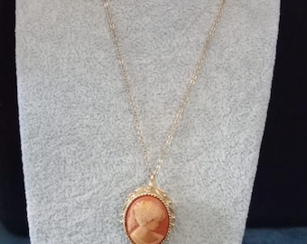 Vintage Sarah Coventry gold tone and coral cameo pendant necklace / brooch