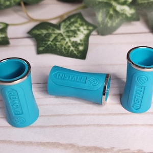 May include: Three turquoise blue plastic caps with silver trim. The caps have the words "INSTALL" and "REMOVE" printed on them.