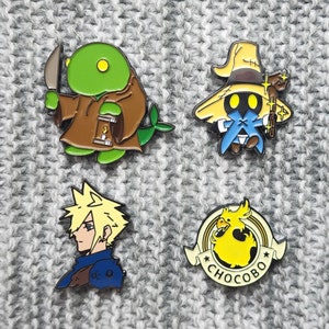 May include: Four enamel pins featuring characters from the Final Fantasy video game series. The pins are on a gray knitted fabric background. The pins depict a green Moogle holding a knife, a black mage wearing a yellow hat, a blonde-haired character with a blue shirt, and a yellow Chocobo with the word "Chocobo" written below it.