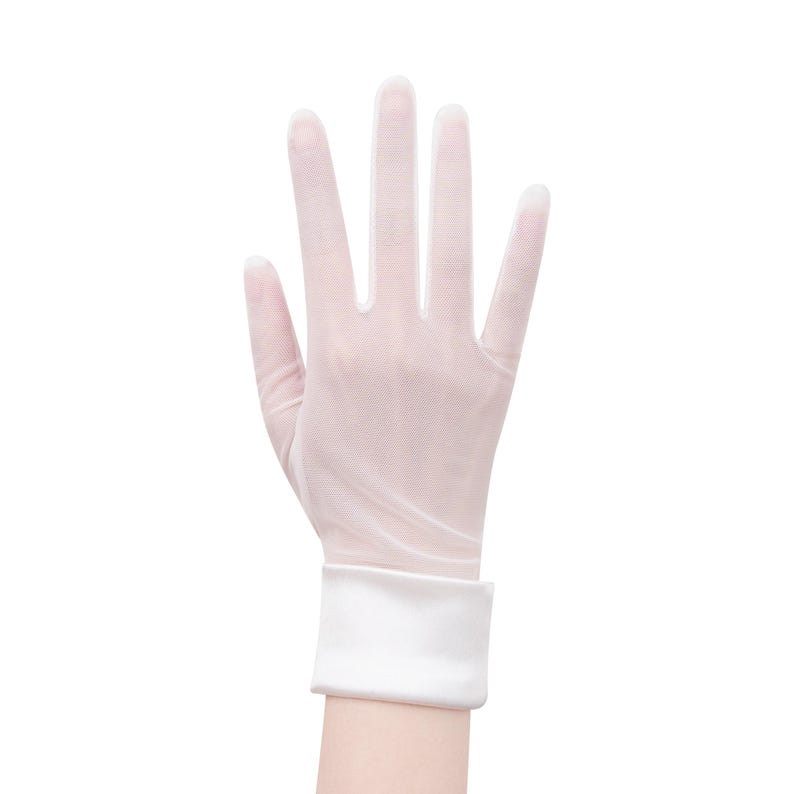 May include: A sheer, pale pink glove with a white cuff, displayed against a white background. The glove is worn on a hand, with the fingers spread open. The cuff is a solid white band.