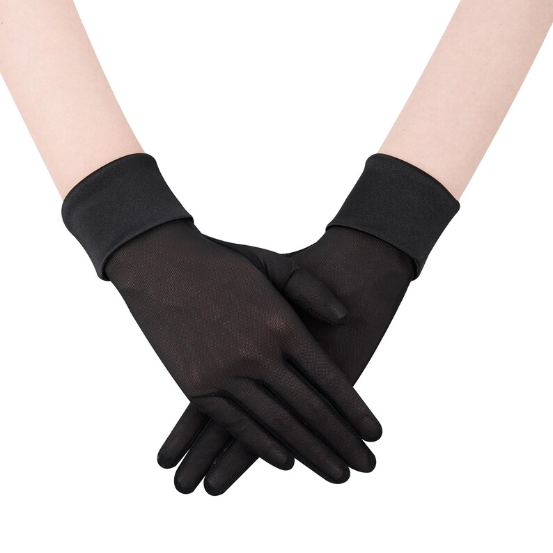 May include: A pair of sheer black gloves. The gloves are made of a lightweight, see-through material. The cuffs are solid black and fit snugly around the wrists. The gloves are designed to cover the entire hand and fingers.