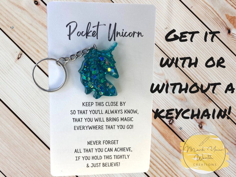 May include: A teal blue glitter unicorn keychain with the text "Pocket Unicorn" and "Get it with or without a keychain!"  The text also reads "Keep this close by so that you'll always know, that you will bring magic everywhere that you go! Never forget all that you can achieve, if you hold this tightly & just believe!" and "Mark Your Worth Creations".