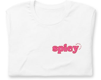 May include: White t-shirt with a pink graphic that says "spicy" with the words "book club" in a circle around the word "spicy".