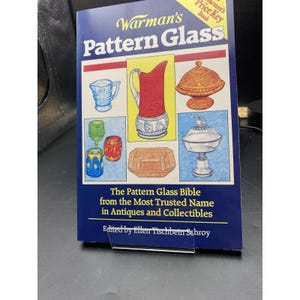 May include: A book titled "Warman's Pattern Glass" with a blue cover and illustrations of various glass patterns. The book includes the text "The Pattern Glass Bible" and "Price Key Book".