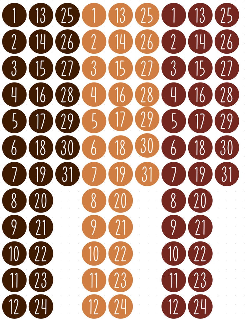 May include: A collection of circular stickers arranged in columns, featuring numbers from 1 to 31 printed in white. The stickers are organised into three distinct colour palettes: dark brown, light tan, and reddish-brown, each set containing the full sequence of numbers.