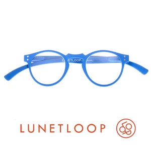 May include: Bright blue round-frame glasses featuring a matte finish and silver-tone rivets at the hinges. The inner bridge of the frame is printed with the text LUNETLOOP. The temples are curved and the overall design is a solid, vibrant blue color.