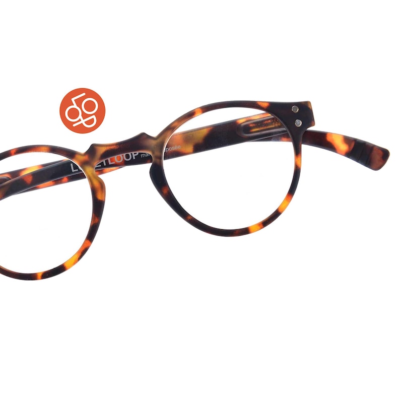 May include: Round eyeglasses with a brown and black tortoiseshell pattern frame. The inner temple arm features the white text LETLOOP. An orange circular logo with the white letters LOP is positioned above the left side of the frame.
