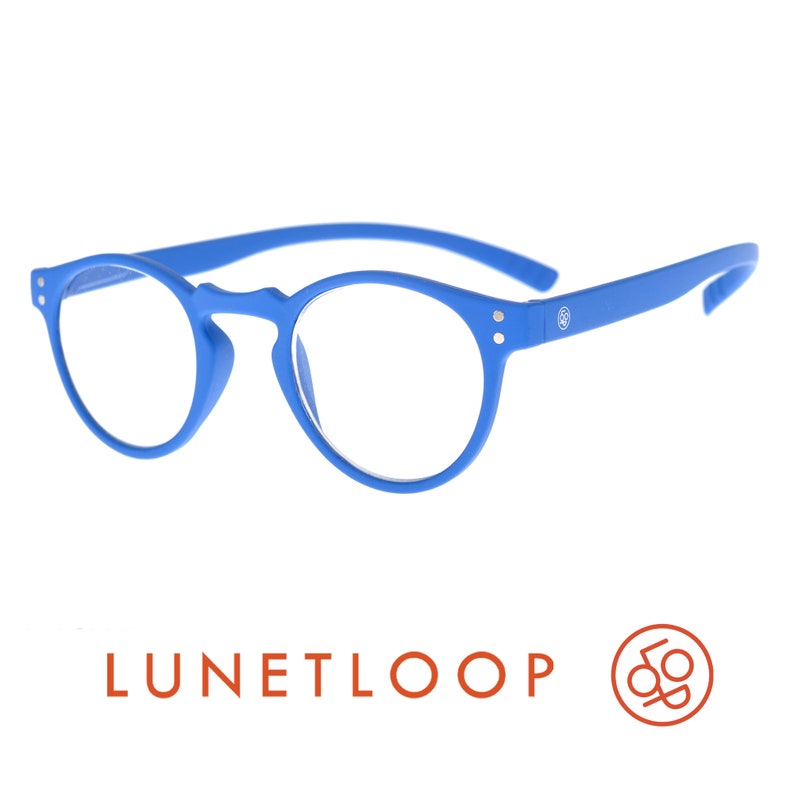 May include: Bright blue round-frame glasses with clear lenses. The frames feature a matte finish, a keyhole bridge, and two small silver-tone rivets on each side. The temple arms are curved, and the text LUNETLOOP is visible below the glasses.