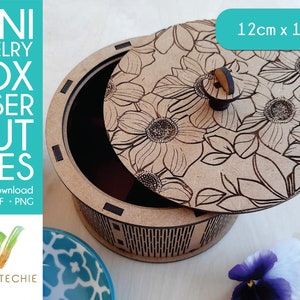 May include: A laser cut wooden jewelry box with a floral design on the lid. The box is 12 inches by 10 inches and has a hinged lid with a knob. The box is made of wood and has a natural finish.