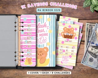 May include: An A6 binder with a 1K Savings Challenge set featuring pink and blue striped inserts. The pages display bear and duck illustrations, the text 'Splash less, save more', and various dollar amounts for tracking savings goals.