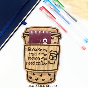 May include: Wooden coffee cup holder with the text "Because my child is the reason you need coffee!" and a small coffee cup with a heart on it. The holder has a slot for a gift card and is decorated with coffee beans and hearts. The text "ASX DESIGN STUDIO" is at the bottom.