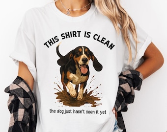 May include: White t-shirt with a black and brown basset hound illustration and the text "This shirt is clean the dog just hasn't seen it yet".